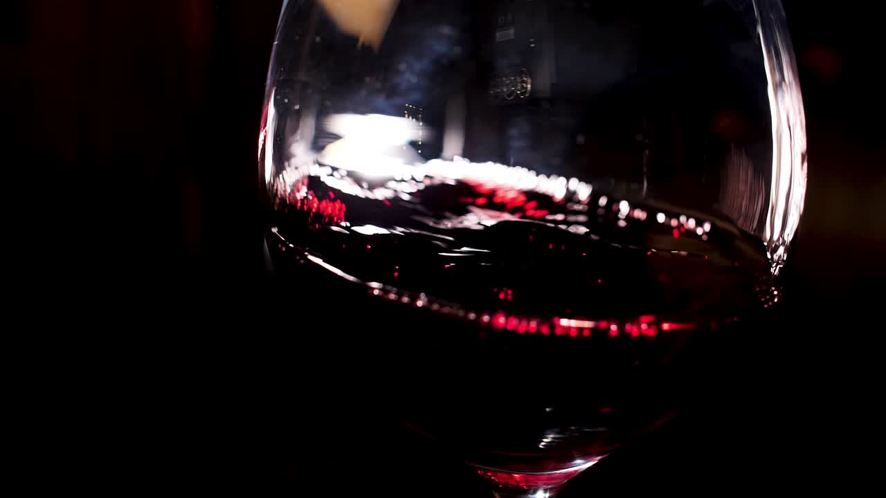 Close-up of a glass of swirling red wine