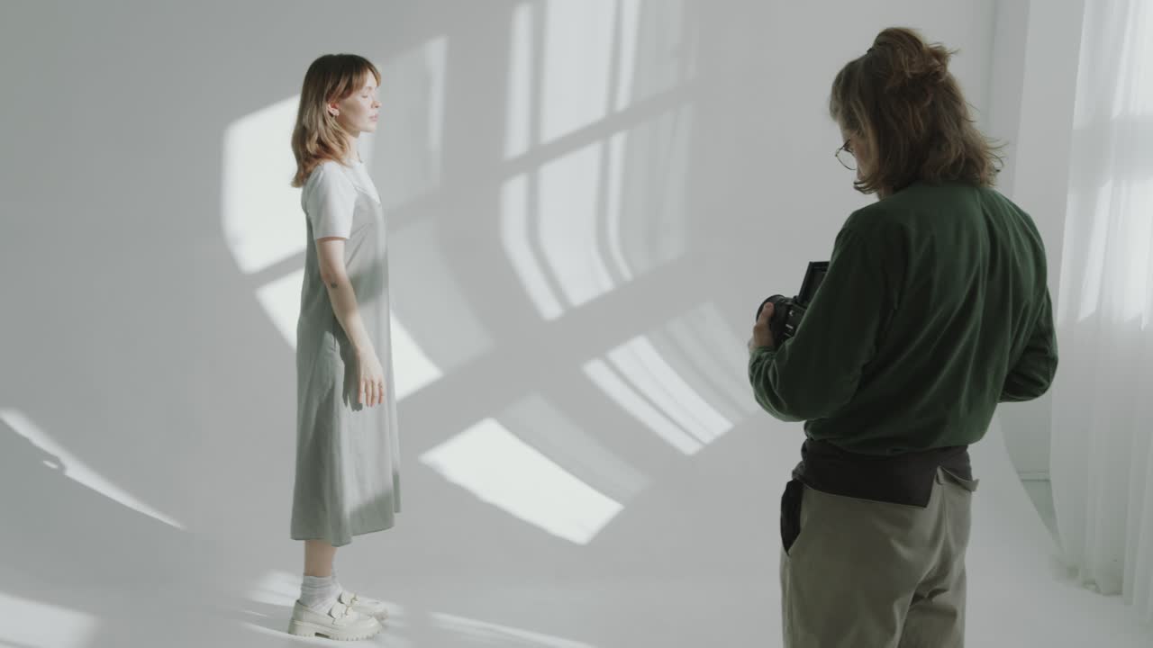 Young Woman Posing on Cyc Wall during Studio Photo Shoot