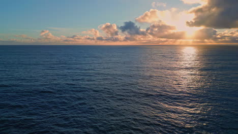 rippling ocean surface reflecting beautiful sunset. aerial view marine sunrise