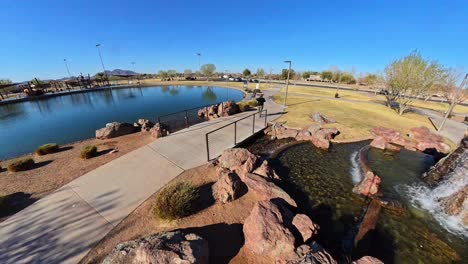 static red haired male walking by a lake in mansel crater park in queen creek arizona.