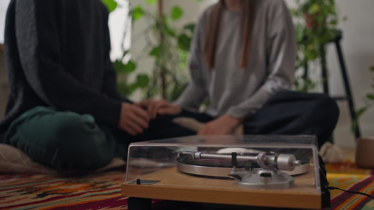 A couple listens to vinyl records at home