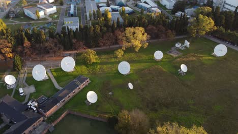 aerial orbit shot of many satellites of research center connecting outdoors