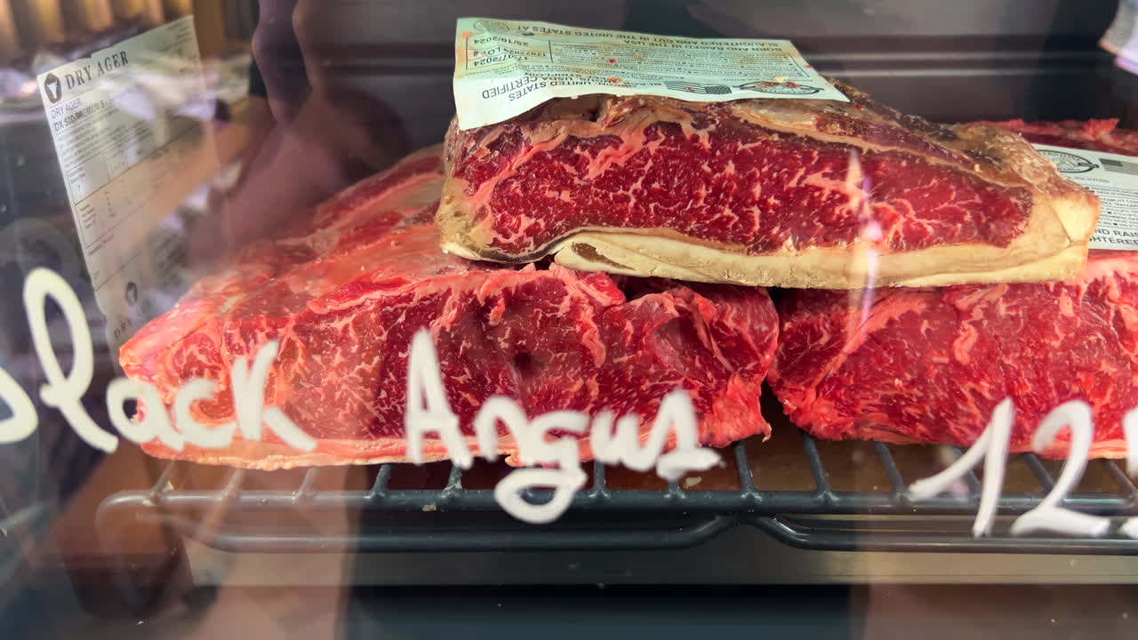 Black Angus beef in a Dry Ager machine fridge for sale in Spain, high quality meat, premium steak in a store, fresh raw meat, butcher shop, 4K shot