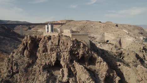 Aerial-pull-out-view-of-San-Telmo-lighthouse-and-beautiful-mountains-in-Almeria