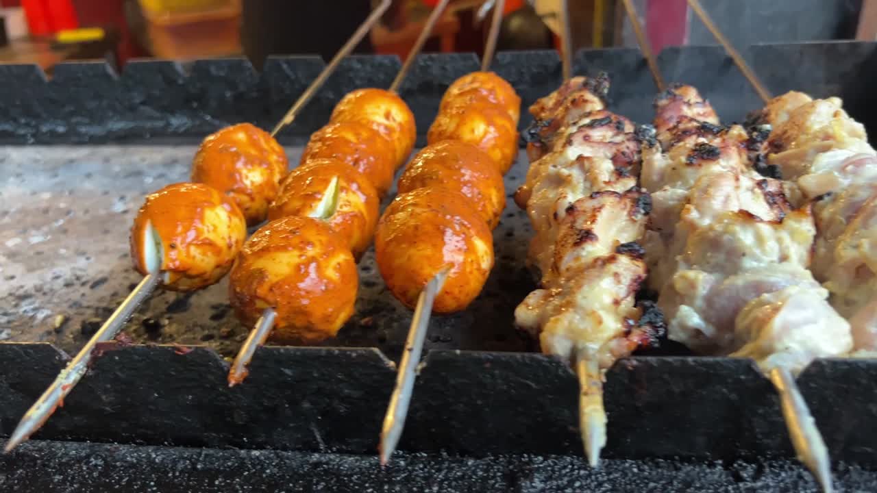 Different types of kababs like egg cheese, reshmi being roasted in skewers in the streets of India