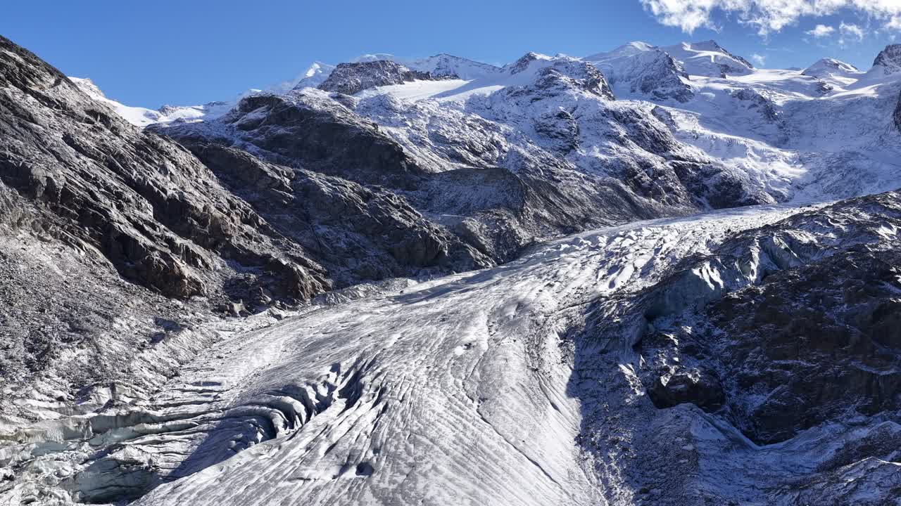 Morteratsch Glacier winds through the snow-covered Bernina Range under clear skies