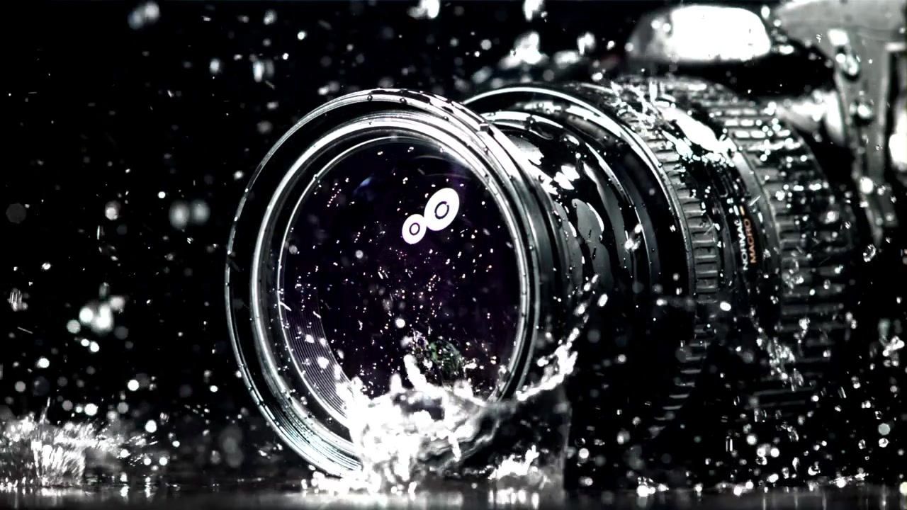 Slow Motion Water Splashing on a Professional Camera Lens