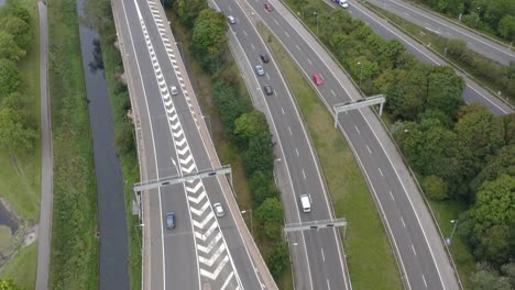 drone shot following train passing underneath motorway bridge 01