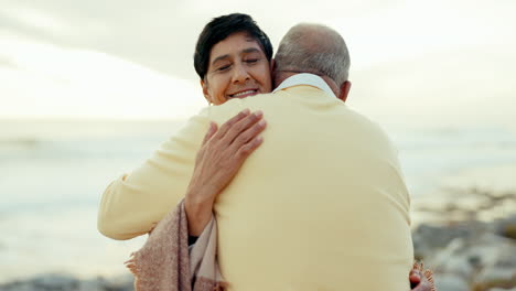 Senior-couple,-love-and-hug-at-beach-for-care