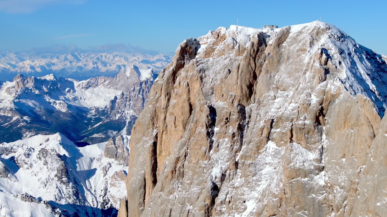 Aerial drone view of the Marmolada mountain in the Dolomites, northeastern Italy with the blue sky on the background