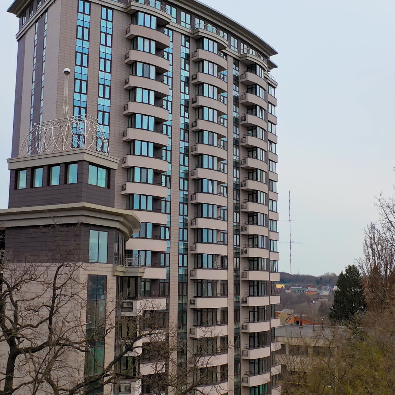 New multy-storey building in the city outside. Beautiful modern high-rise public housing apartments. Camera moves forward.