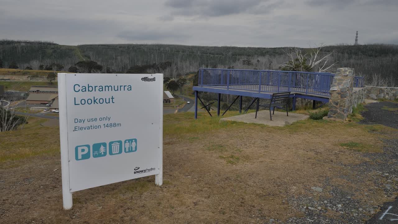 View from Cabramurra lookout including signage and the town in the Snowy Mountains region of New South Wales.