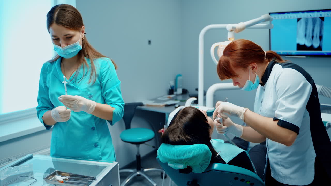 Girl in dental clinic. Woman having teeth examined at dentists