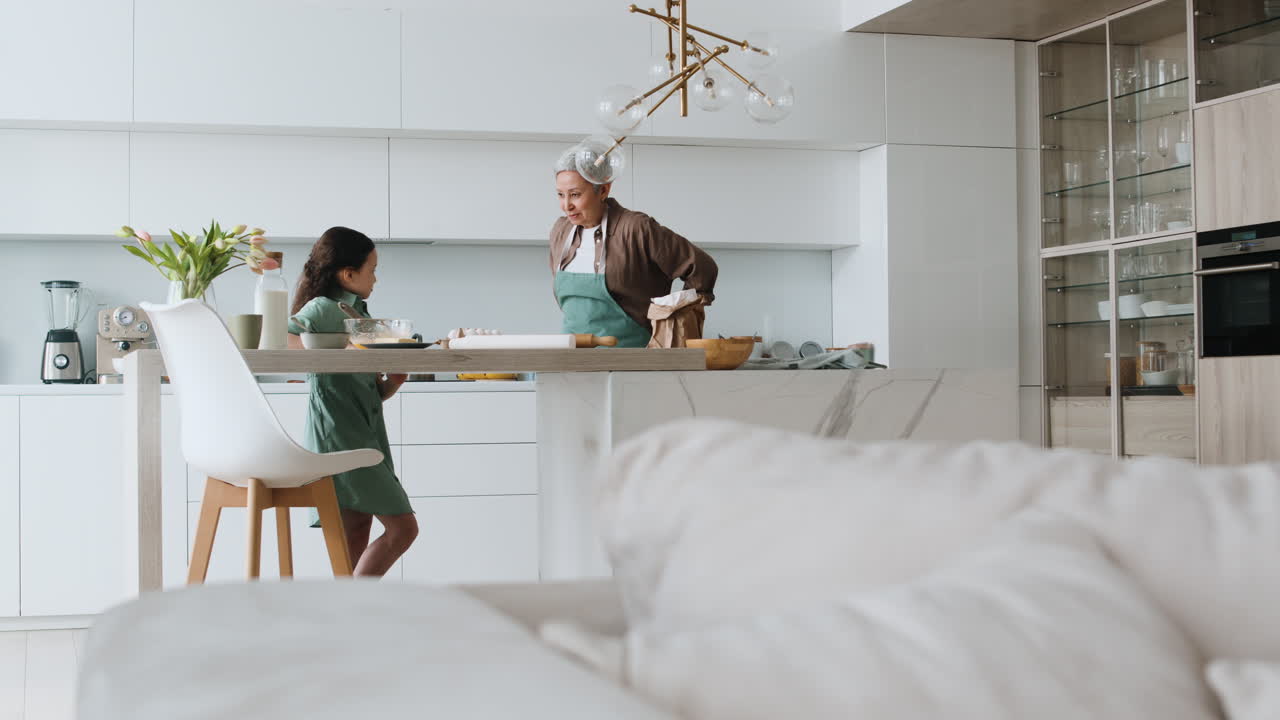 Grandma and girl wearing aprons