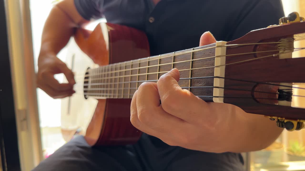 cheerful man playing solo acoustic guitar inside iran tehran cafe wooden instrument melody rhythm music emotional fun happy leisure hobby of musician modern style portrait millennial sitting song