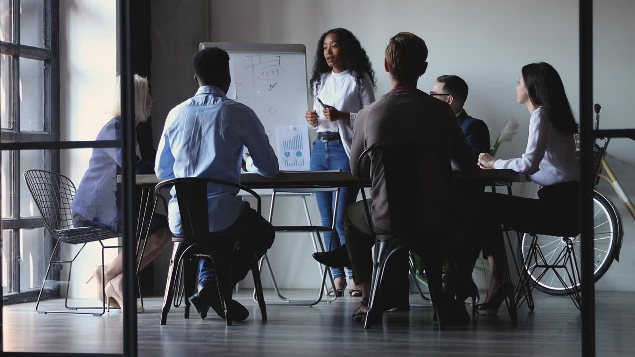 Millennial biracial businesswoman speaker giving educational lecture to employees.