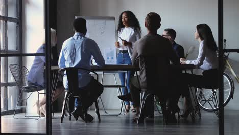 millennial biracial businesswoman speaker giving educational lecture to employees.