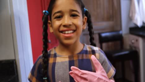 Girl-wearing-gloves-in-kitchen-4k