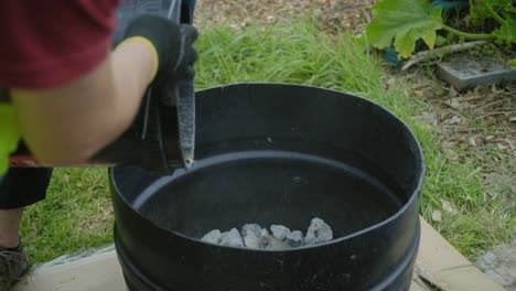 pouring out stones vermiculite rocks out of the bucket to a big container