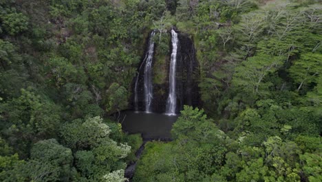 dramatic aerial footage of famous wailua river with pacific ocean coastline and a driveway in the background