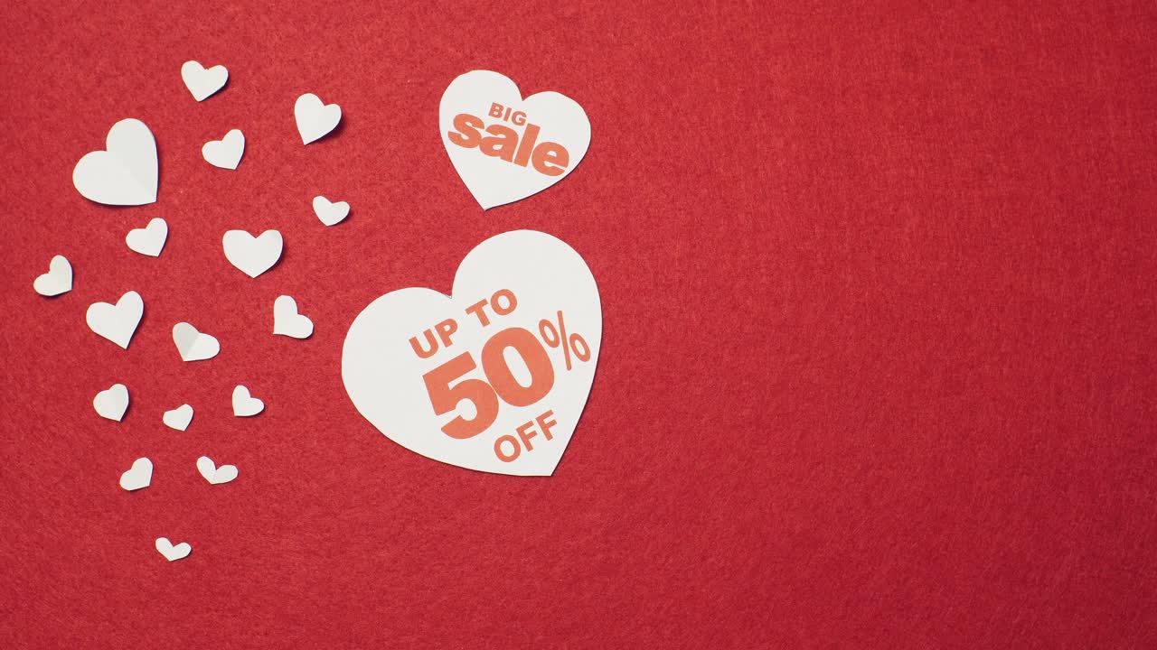 White hearts for big sale on the red background. 14 february sale
