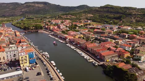 Establishing-aerial-shot-of-Bosa-small-town-with-picturesque-houses-facing-river