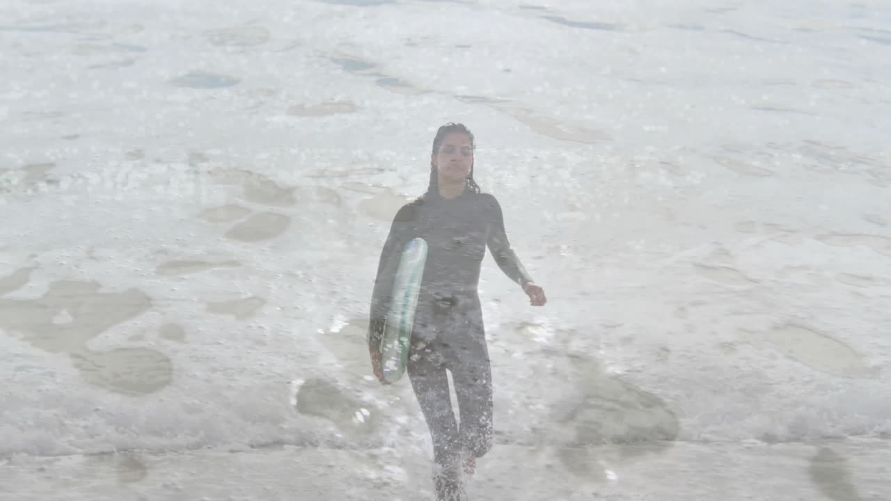 woman walking from surf onto beach, showing animated wave height charts and metrics in sports
