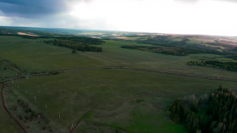 aerial view of a rural landscape with fields, forests, and roads