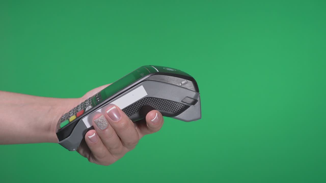 Close up female hold in hand wireless modern bank payment terminal to process acquire credit phone payments on green screen. Copy space mock up advertising, man pay