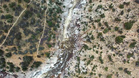 top down aerial view of a river with raging waters in deep creek, hesperia desert in california, usa