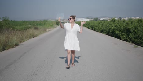 woman taking a selfie on a country road