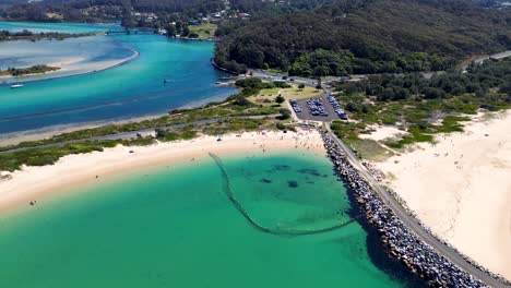 drone aerial channel bar beach wagonga inlet channel rock wall headland coastline travel holiday destination swimming spot bay nsw south coast narooma australia 4k