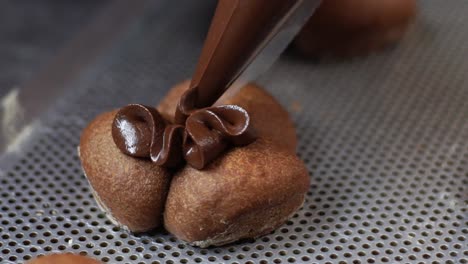 decorating with liquid chocolate on a cookie