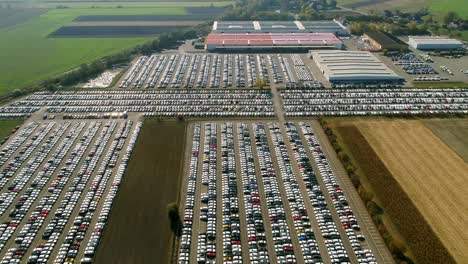 Aerial-footage-of-finished-cars-ready-to-be-shipped-on-huge-distribution-center