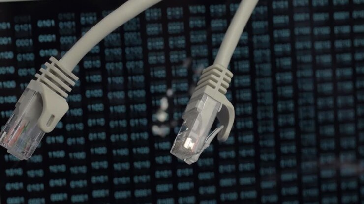 Ethernet network cables with green binary data output background