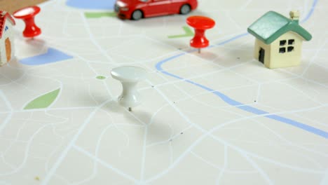 close up shot hand of children pinning the target pin to the map, metaphor destination of the trip and journey, select focus shallow depth of field