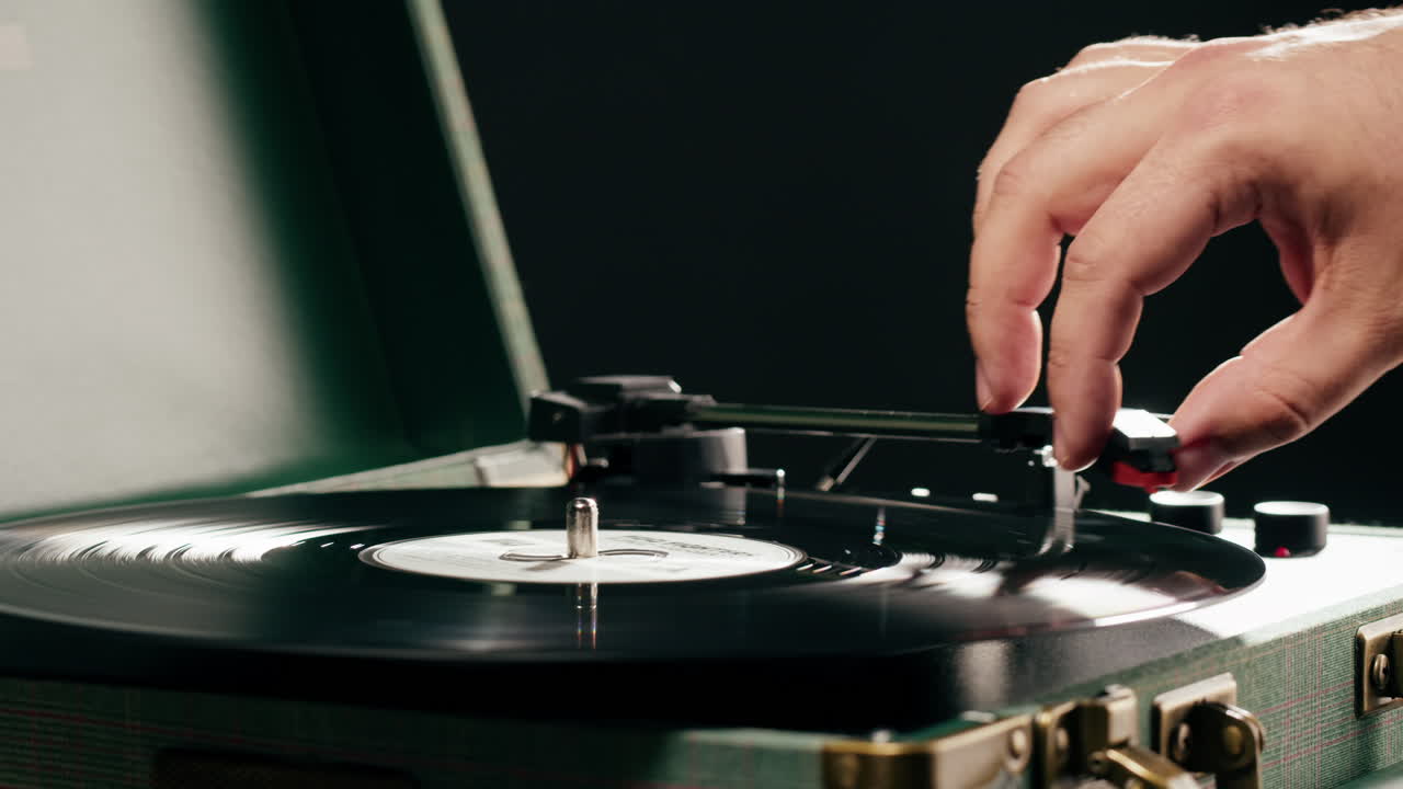 Mano che posiziona l'ago su un disco in vinile su un giradischi vintage