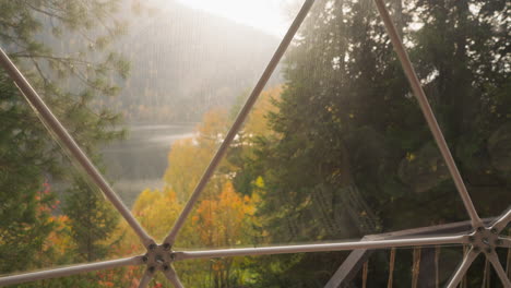 mountain river view from glass terrace. modern glamping accommodation to rest enjoying calm view of autumn nature. cottage house near river for rent