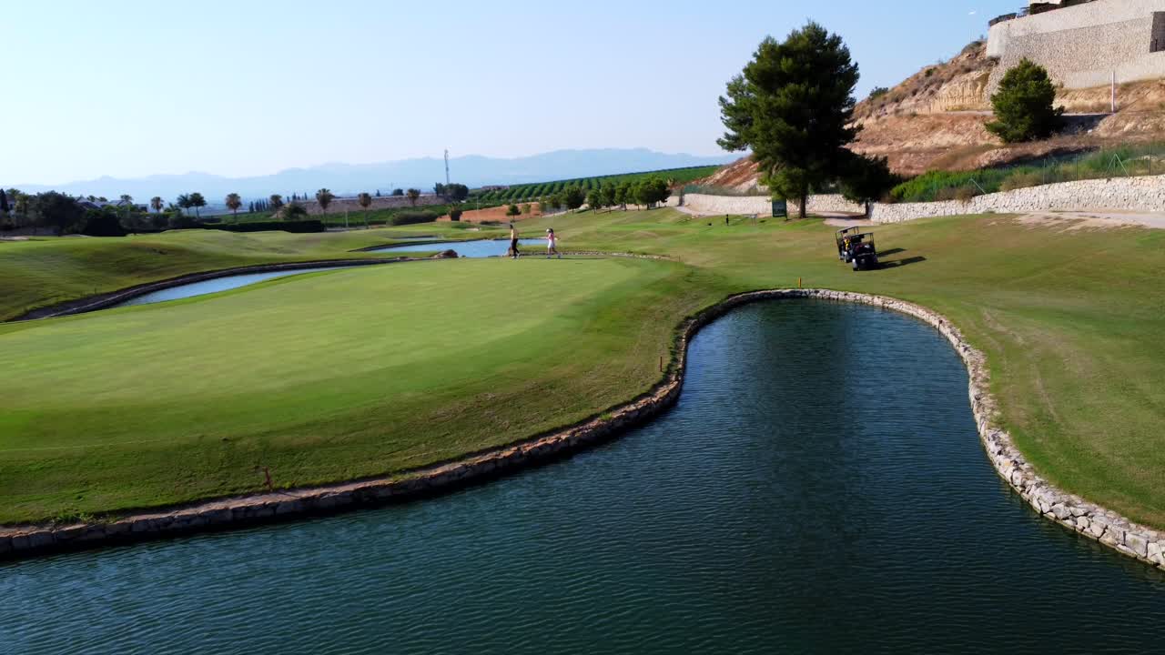 Golf course with lake and golf cart