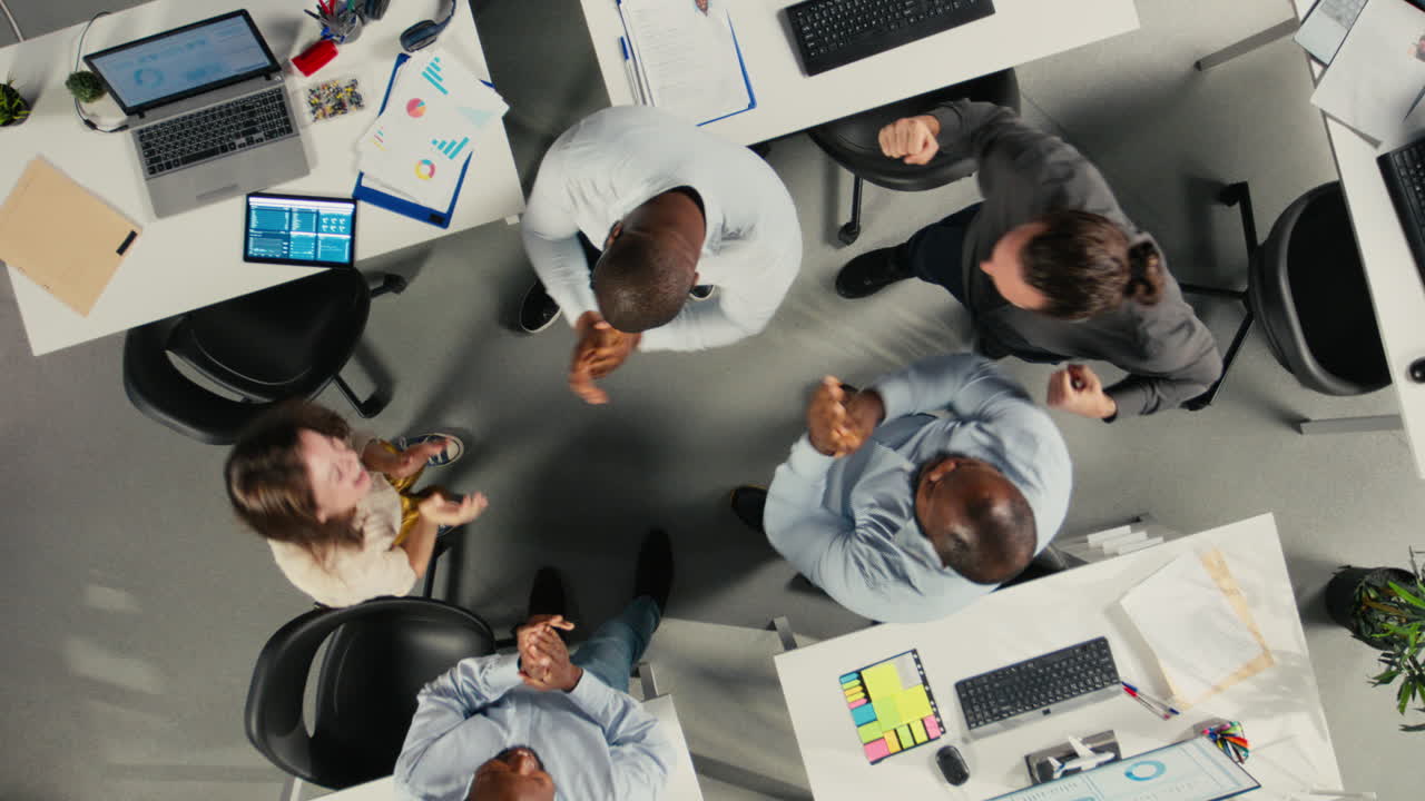 Vertical Video Top down view zoom in of staff proud of their successful teamwork