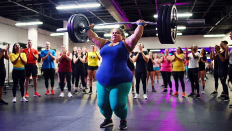 plus-size woman weightlifting in a supportive gym environment