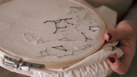 crop faceless woman doing embroidery with hoop at home