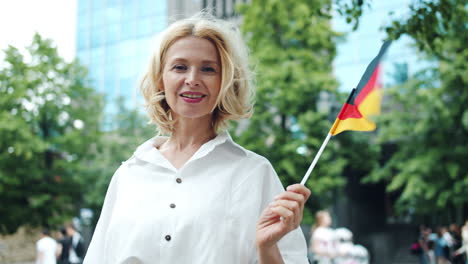 woman holding a flag in a city