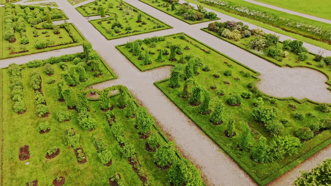 Tourism concept drone turns above geometric greenery at iconic Rundāle garden