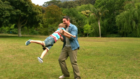 father and son playing in a park