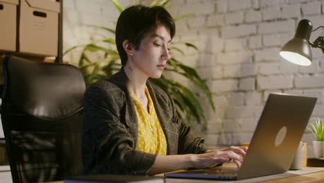 woman working on laptop at night