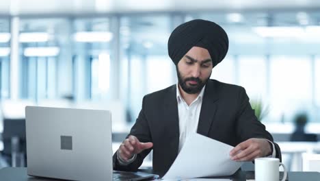 busy sikh indian businessman working on laptop