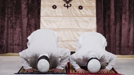 muslim men doing sujud prayer at home