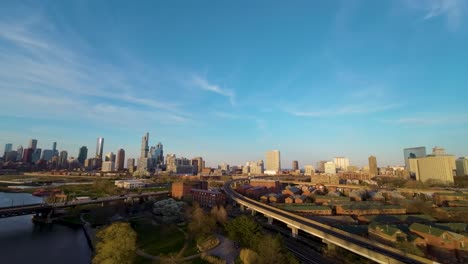 aerial-drone-footage-of-the-Chicago-Chinatown-cityscape-with-river,-bridge,-and-skyscrapers-during-golden-hour