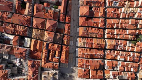 an aerial view of dubrovnik's red-roofed old town buildings, symmetry, and streets
